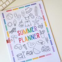 printed summer planner on desk with keyboard.
