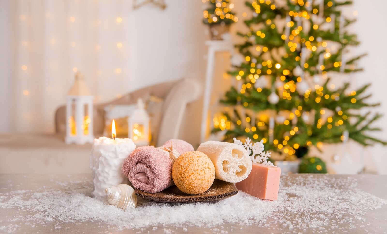 Self care and pamper items in front of christmas tree.